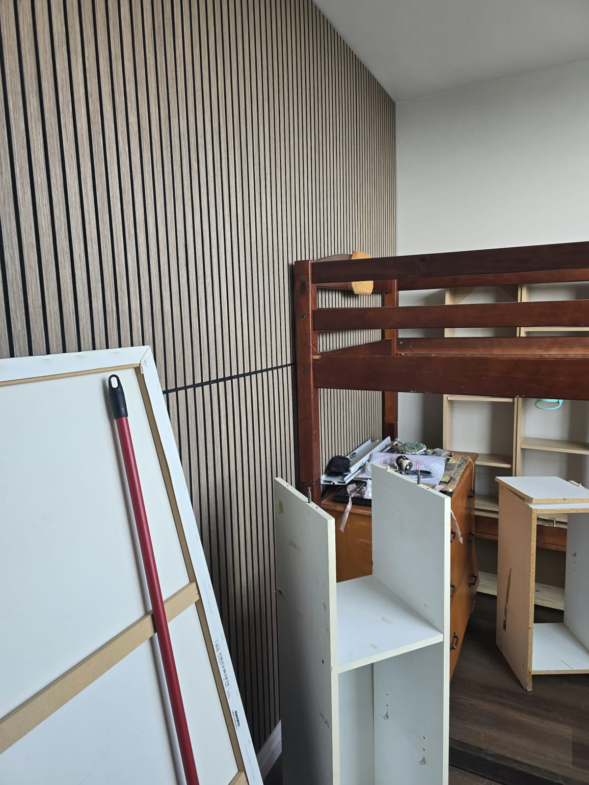 First of the two finished rooms with a wood-slat accent wall