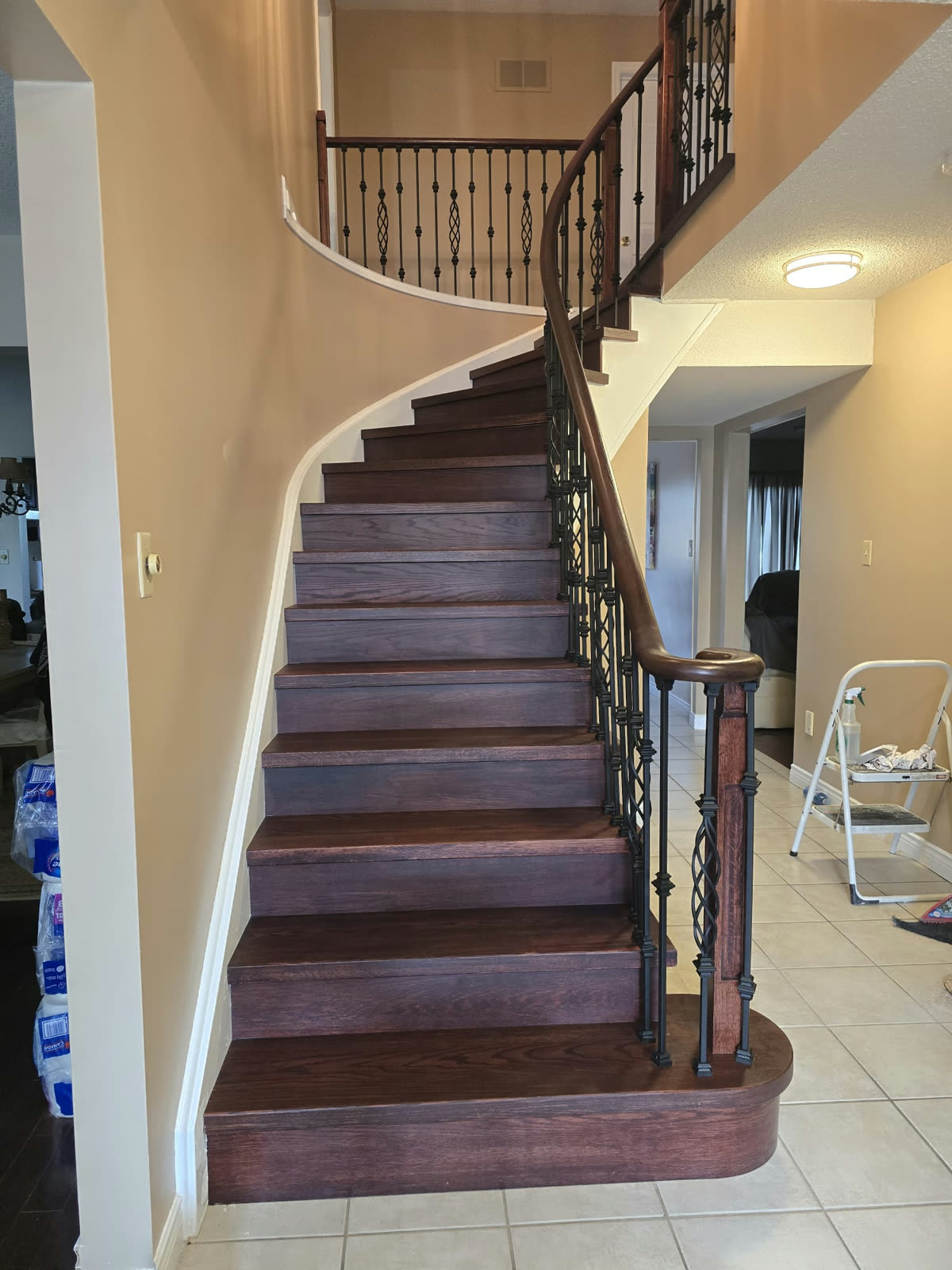 Stairs after: dark stained treads, new hand rail and black iron balusters