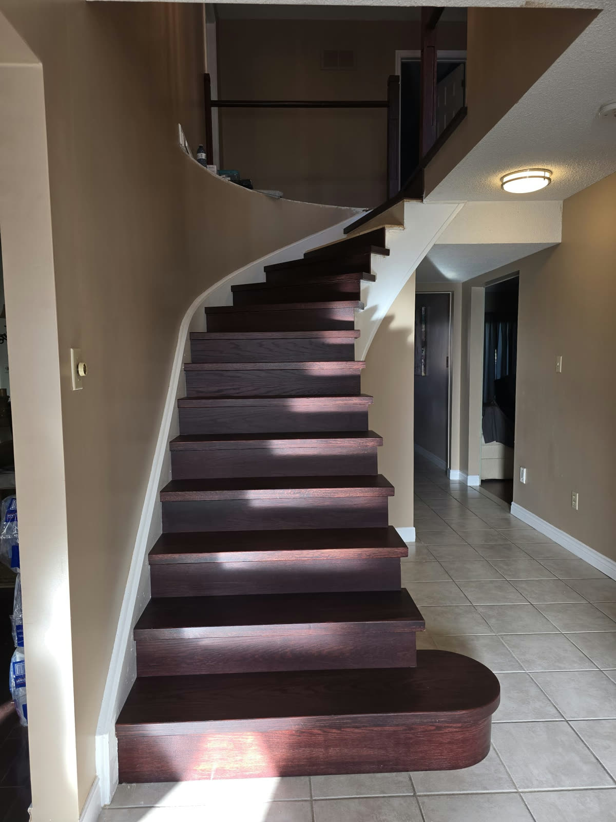 Stairs with new dark treads and risers but no hand rail installed yet